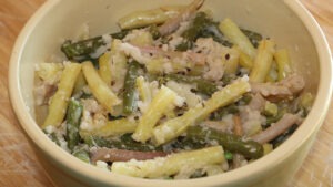 A white bowl with a mash of multicolored long beans and spices