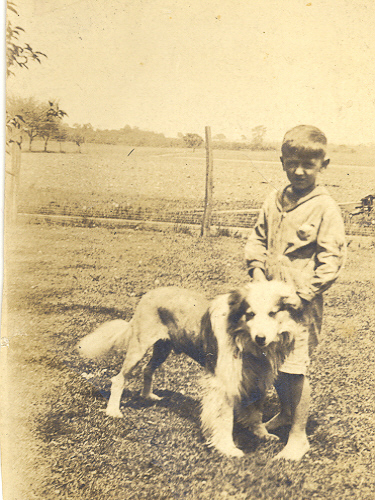An old photo of a young boy with a dog