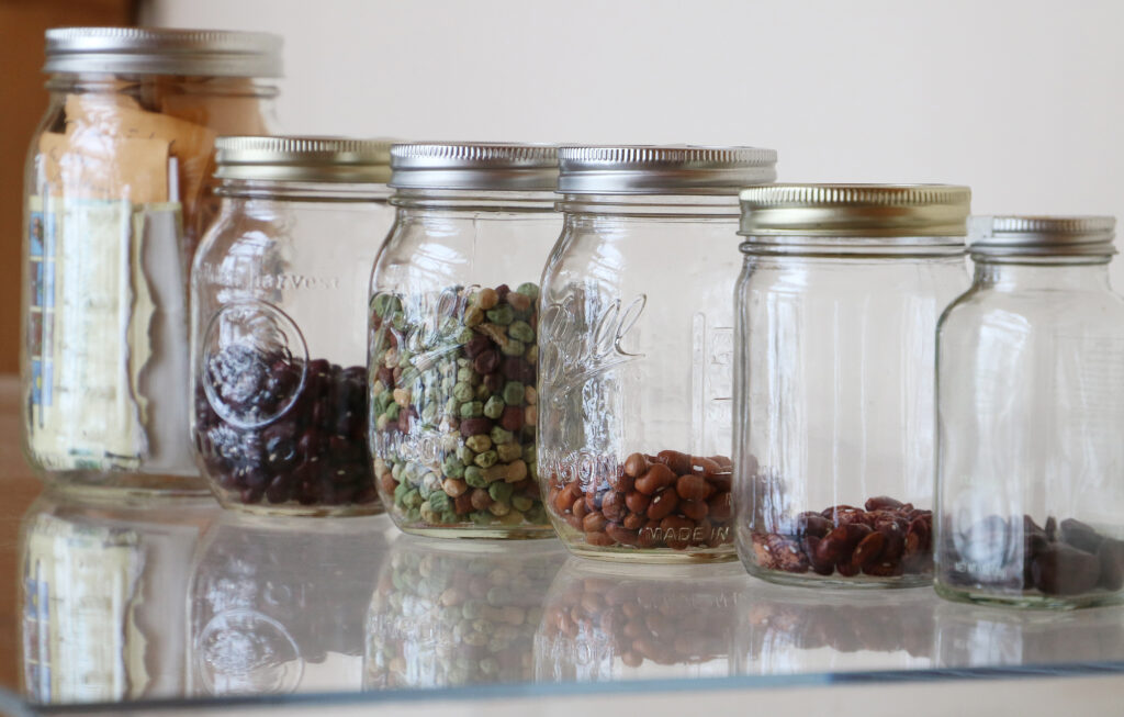 Seeds in five glass mason jars.