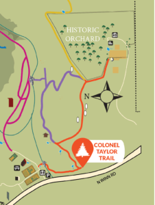 A map showing a trail labeled "Colonel Taylor Trail", marked in orange, which leads from a group of gardens and buildings to an area marked "Historic Orchard"