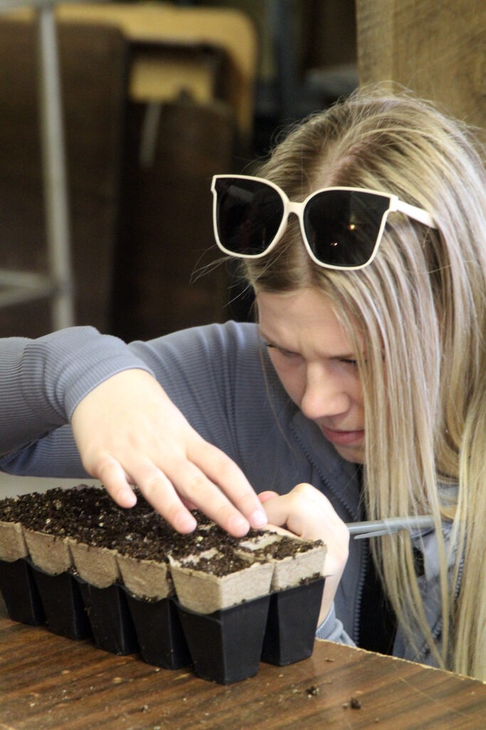 Woman labels seed starts.