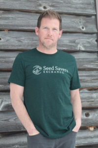 adult male wearing hunter-green short-sleeved T-shirt with SSE logo