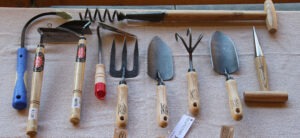 nine common garden tools lying on a light background