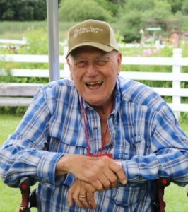 Person wearing a hat smiling at camera.