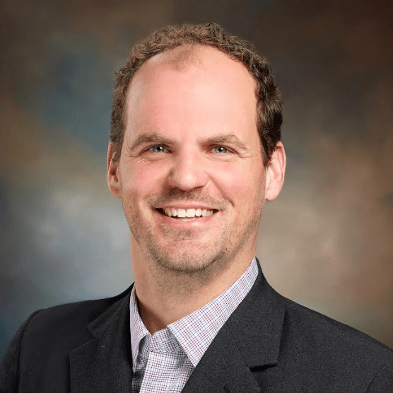 Man in a navy blue blazer.