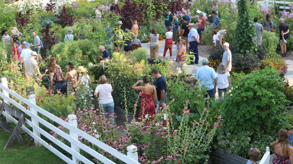 Visitors exploring a garden at Heritage Farm.